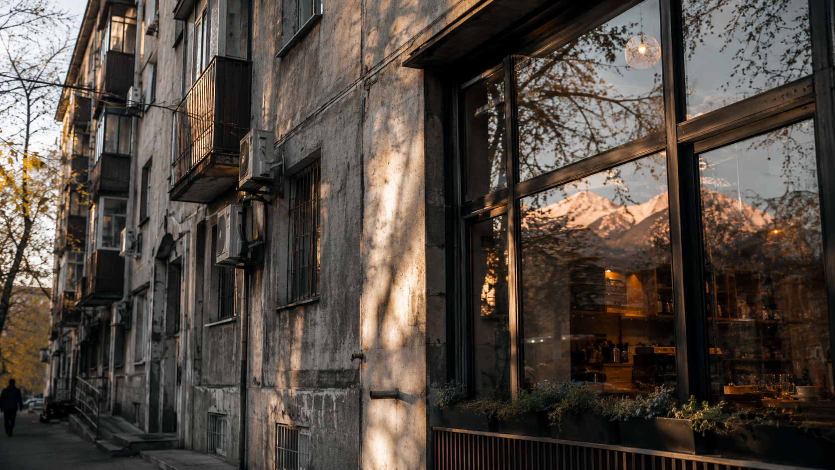Soviet concrete and modern cafe reflection showing Almaty’s evolving city identity.