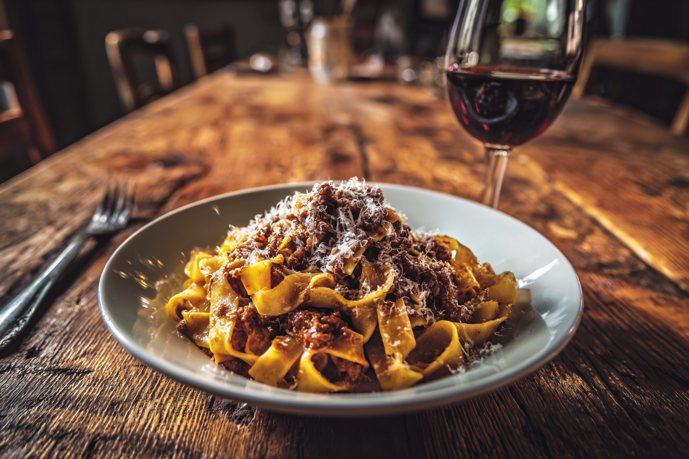 A plate of authentic Tagliatelle al Ragù served in a traditional Bologna restaurant, a highlight of Italian cuisine.