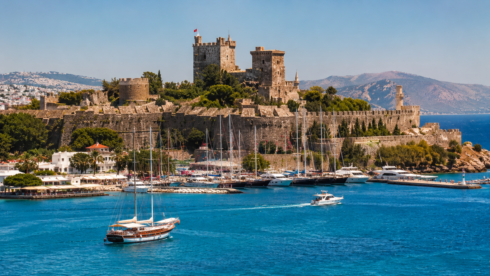 Bodrum Castle overlooking turquoise Aegean water, marina, and white boats