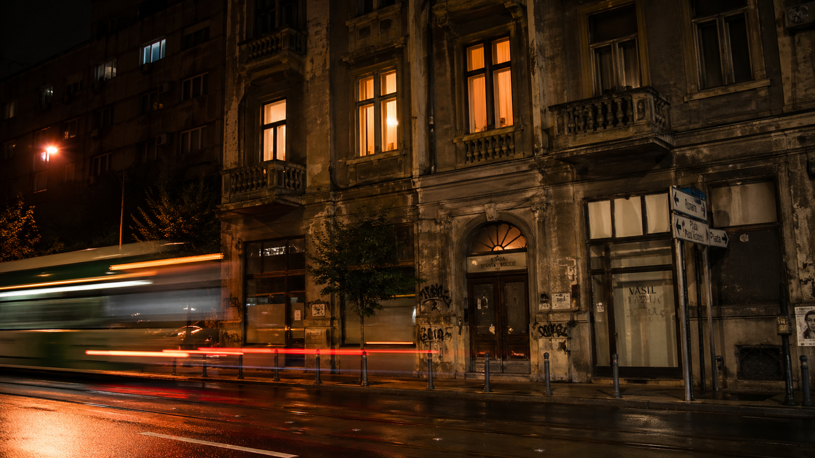 Bucharest travel guide: Bucharest street at night with warm windows and quiet unfinished-city atmosphere.
