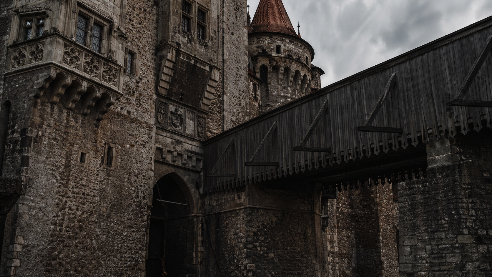Close-up of Corvin Castle bridge and tower in dark medieval atmosphere.