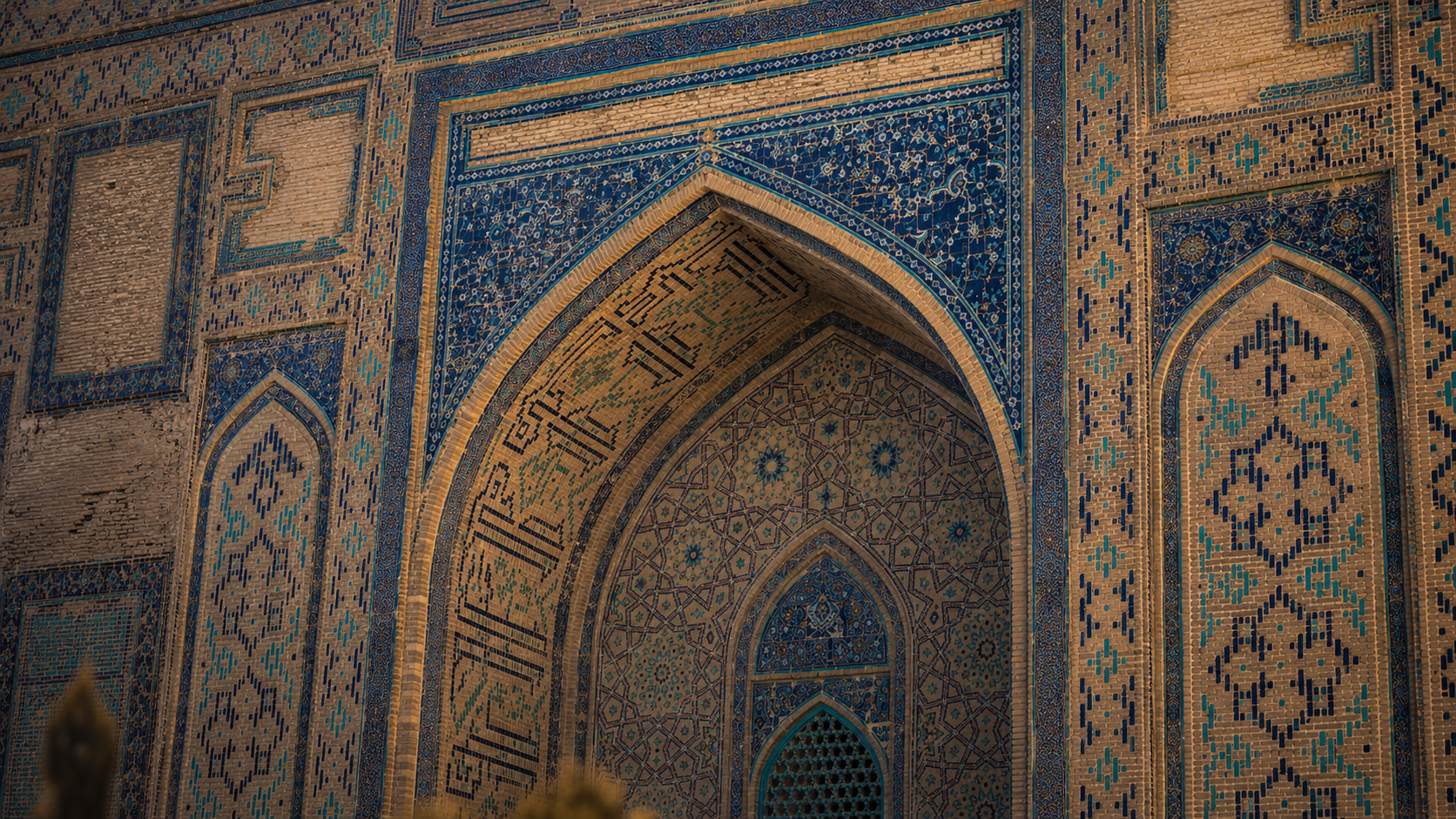 Turquoise tilework and carved portal detail at Khoja Ahmed Yasawi Mausoleum.