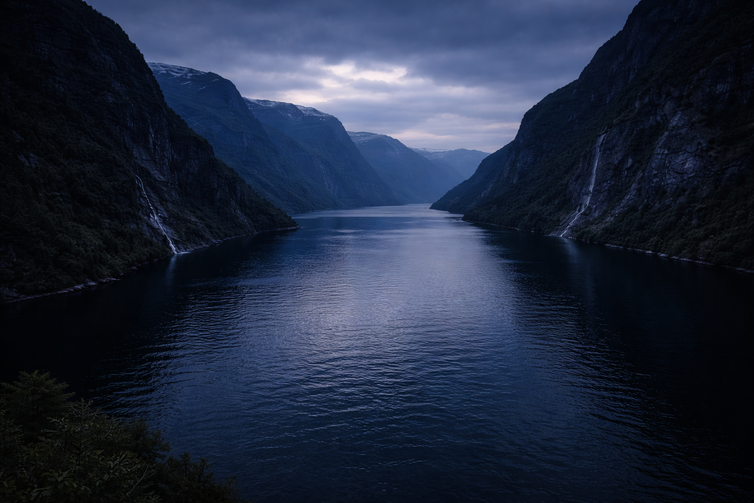 Norwegian fjord at blue hour with dark water, fading cliffs, and deep silence.