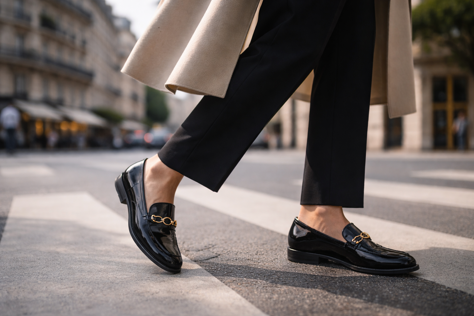 Paris fashion guide: Polished loafers crossing a Paris street with soft Haussmann blur behind.
