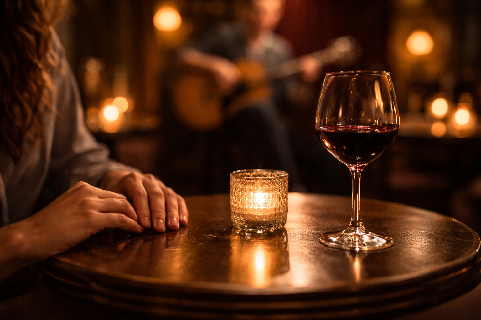 Candlelit jazz table close-up with warm reflections and blurred music behind.