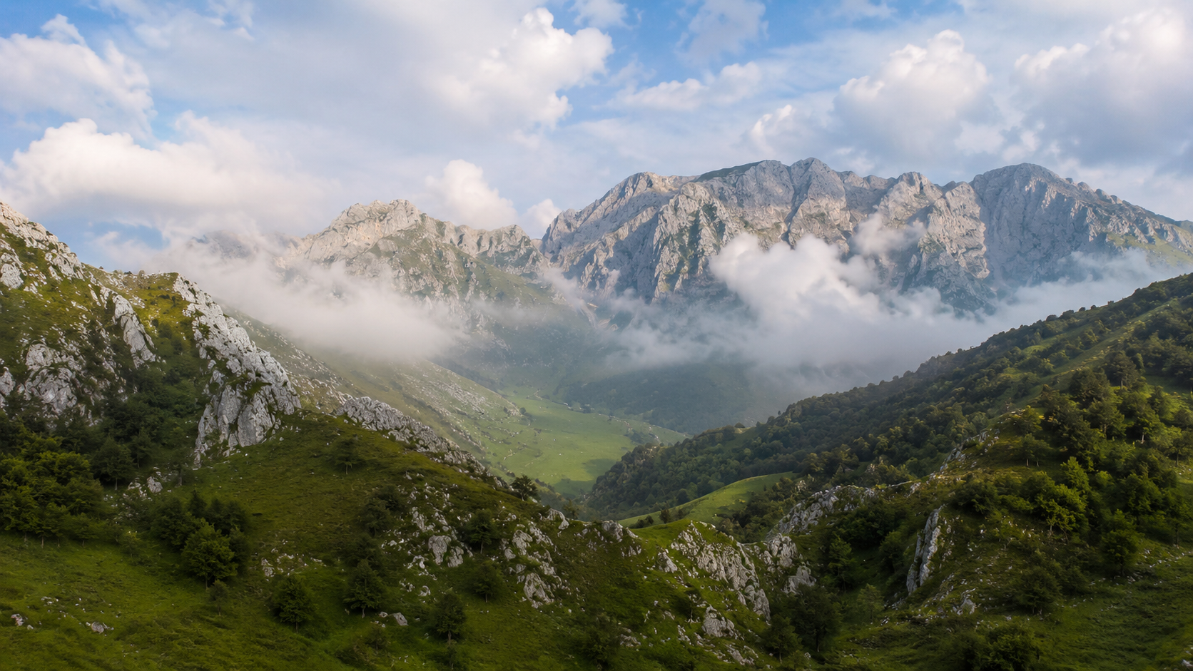 Green valleys and limestone peaks in Picos de Europa in northern Spain.