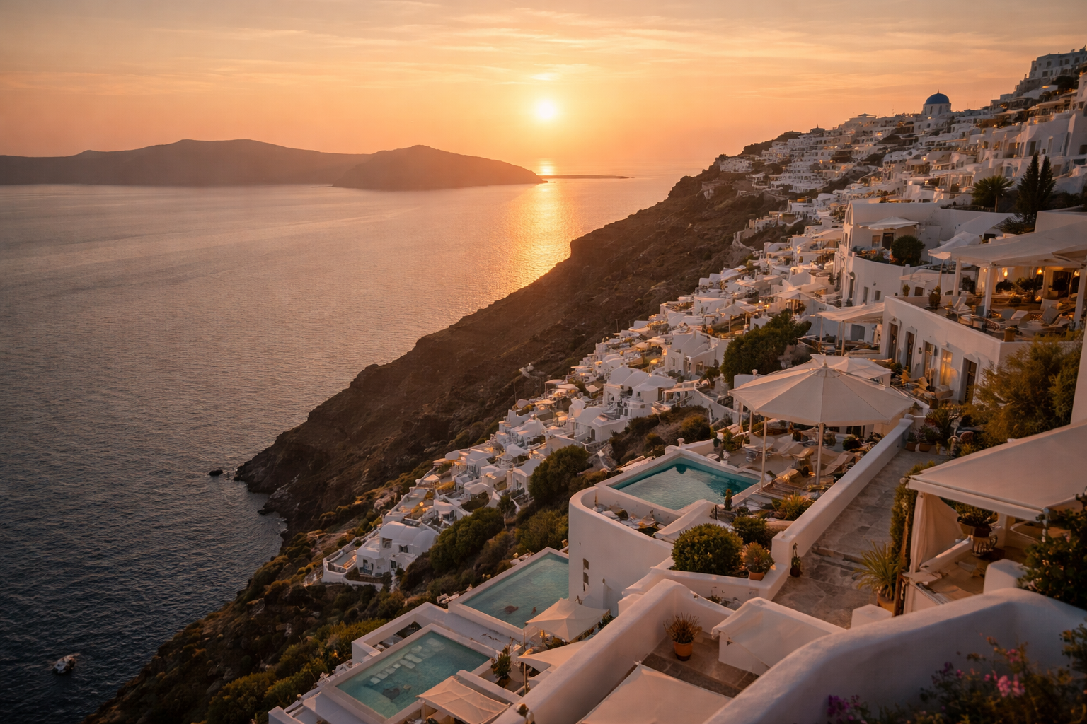 Wide cinematic view of the Santorini caldera at sunset with white terraces and soft sea haze.