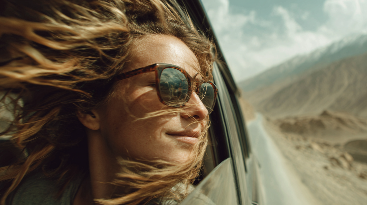 Close-up of a traveler with the Karakoram Highway reflected in sunglasses.