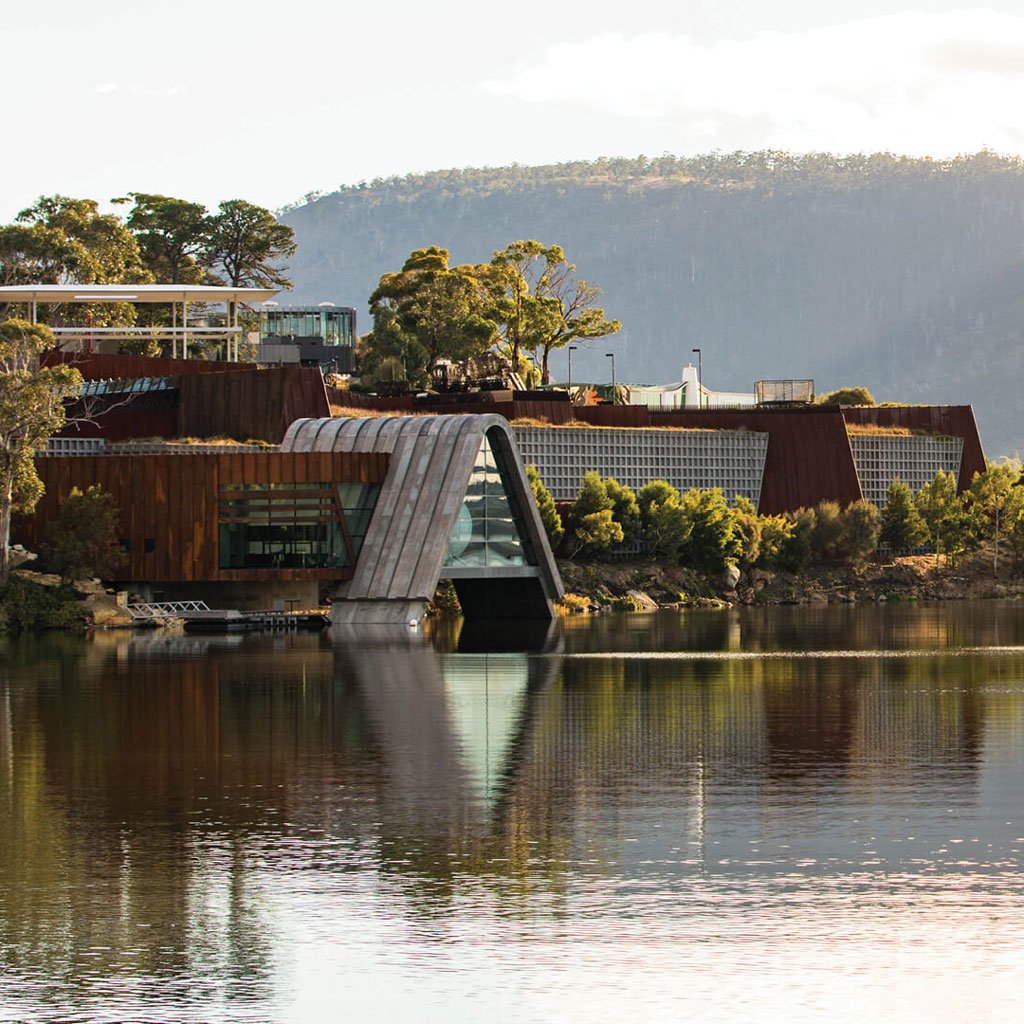 An image showcasing the unique architecture of the Museum of Old and New Art (MONA) in Hobart, Tasmania, with its subterranean galleries and surrounding vineyards.