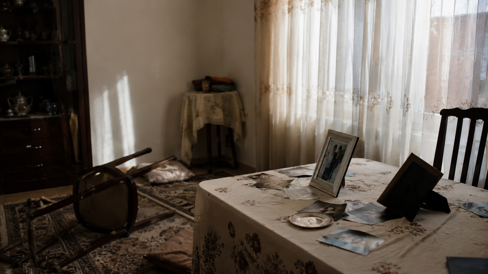 Quiet home interior with family photos and overturned chairs symbolizing civilian trauma