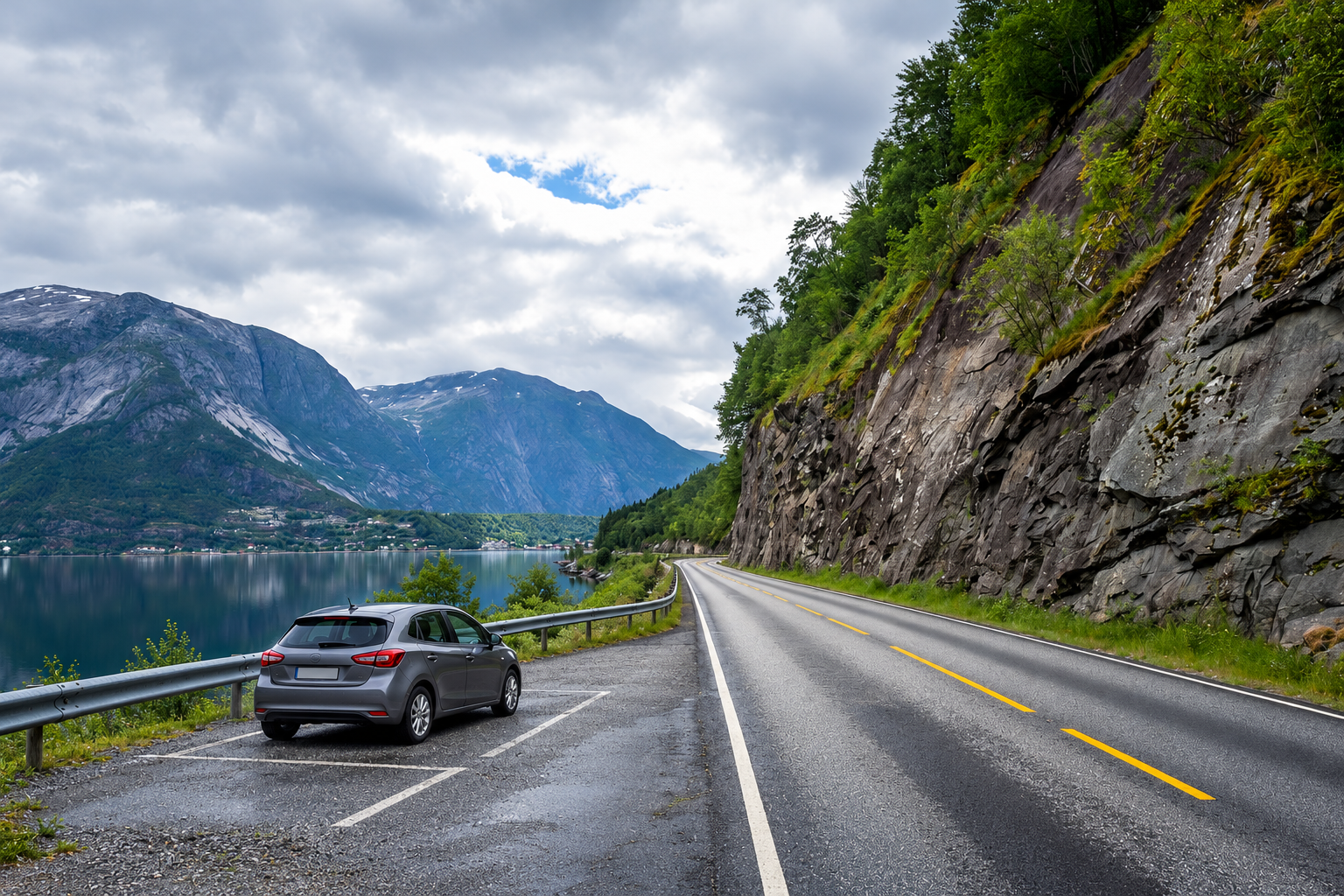 Compact rental-style car parked in a designated bay beside a Norwegian fjord